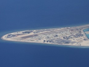 An airstrip, structures and buildings on China's man-made Subi Reef in the Spratly chain of islands in the South China Sea are seen from a Philippine Air Force C-130 transport plane April 21, 2017.