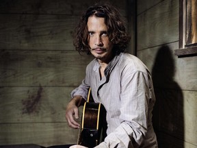 FILE - In this July 29, 2015, file photo, Chris Cornell plays guitar during a portrait session at The Paramount Ranch in Agoura Hills, Calif. Cornell's finale music video, filmed before the singer died in May, was released Tuesday, June 20, 2017. (Photo by Casey Curry/Invision/AP, File)