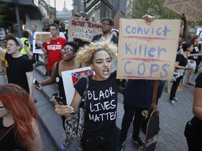 Protesters chant outside Nippert Stadium before a soccer game during a demonstration on the University of Cincinnati campus demanding that a white former police officer, Ray Tensing, be tried a third time in the fatal shooting of an unarmed black motorist, Wednesday, June 28, 2017, in Cincinnati. A mistrial was declared twice in the murder and voluntary manslaughter case of Tensing, who was a University of Cincinnati police officer when he shot Sam DuBose during a 2015 traffic stop. (AP Photo/John Minchillo)