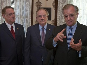 FILE - In this Aug. 15, 2011, file photo, former state Comptroller John Sharp, right, speaks to members of the media as Texas A&M University Board of Regents Chairman, Richard Box, center, and Regent Jim Schwertner, left, looks on after Sharp was named the sole finalist for chancellor of the Texas A&M University System in Austin, Texas. Sharp is the third highest paid public university president in the nation with an income of $1.3 million. (Rodolfo Gonzalez/Austin American-Statesman via AP, File)