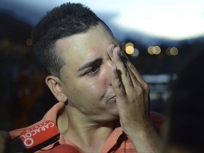 Gilberto Villegas, a ferry passenger who survived after it sank in a reservoir, cries as he talks to the press in Guatape, Colombia, Sunday, June, 25, 2017. Villegas said two of his relatives are still missing.