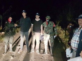 In this photo released by Colombia's Ombudsman Press Office, rebels of Colombia's National Liberation Army, ELN, release Dutch journalists Derk Bolt, second from left, and Eugenio Follender, second from right, north of Santander, Colombia, Saturday, June 24, 2017. The two Dutch journalists, who were held captive for almost a week by the leftist rebels in Colombia, were released unharmed, Dutch Foreign Affairs Minister Bert Koenders said early Saturday. (Colombia's Ombudsman Press Office via AP)