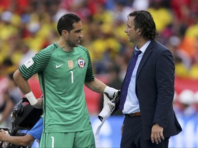 FILE - In this Thursday, Nov. 10, 2016 file photo, Chile goalkeeper Claudio Bravo, left, talks to coach Juan Pizzi during a 2018 World Cup qualifying soccer match against Colombia in Barranquilla, Colombia. Chile coach Juan Antonio Pizzi says Claudio Bravo is fit again and could start in goal against Australia at the Confederations Cup on Sunday. Bravo hasn't played since April 27, when he injured his calf for Manchester City in a derby game with Manchester United. (AP Photo/Fernando Vergara, File)