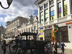 In this photo taken on Wednesday, June 21, 2017 people take a stroll along Bauman Street, in Kazan, Russia. Fans visiting the exotic city of Kazan get to experience a little bit of everything during the Confederations Cup: rich history, diverse culture, magnificent buildings, and even a beach. (AP Photo/Tales Azzoni)