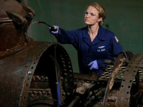 Conservator Anna Funke sprays sodium hydroxide on the H.L. Hunley in the Warren Lasch Conservation Center in North Charleston, S.C., Wednesday, June 7, 2017