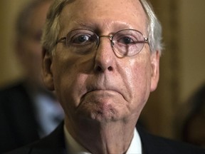 In this June 27, 2017, photo, Senate Majority Leader Mitch McConnell, R-Ky., tells reporters he is delaying a vote on the Republican health care bill at the Capitol in Washington. Congressional Republicans are stymied over health care. But after seven years of promising to repeal and replace former President Barack Obama's law, they risk political disaster if they don't deliver. (AP Photo/J. Scott Applewhite)