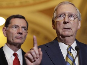 FILE - In this May 23, 2017, file photo, Senate Majority Leader Mitch McConnell of Ky., right, accompanied by Sen. John Barrasso, R-Wyo., speaks on Capitol Hill in Washington. The Republican effort to secretly craft a health care bill and whisk it through the Senate is striking, and it's drawing fire from members of both parties. But it's not uncommon for either party to draft bills or resolve stubborn final hurdles behind closed doors, foregoing the step-by-step, civics-book version of how Congress works. Lacking the votes to block this year's GOP effort, Democrats are looking to score political points by targeting the closely-held process McConnell is using to write legislation replacing much of Obama's statute. (AP Photo/Jacquelyn Martin, File)