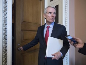 Sen. Rob Portman, R-Ohio, pauses for a reporter's question as he arrives at a closed-door GOP strategy session on the Republican health care overhaul with Vice President Mike Pence, Senate Majority Leader Mitch McConnell, R-Ky., and others, at the Capitol in Washington, Tuesday, June 20, 2017.