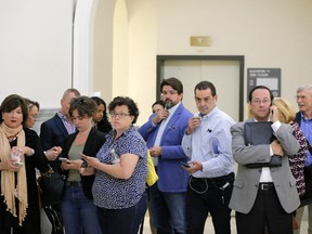 Journalists wait to re enter the courtroom after being called back in during the fifth day of deliberations in Bill Cosby's sexual assault trial at the Montgomery County Courthouse on June 16, 2017.