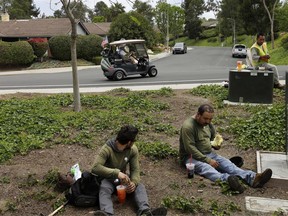 FILE - In this May 4, 2016, file photo, Duncan Wallace drives a golf cart from his house to his golf club as a group of landscape workers take a break in Vista, Calif. The United States is growing older and more ethnically diverse, a trend that is could put strains on government programs from Medicare to education, the Census Bureau reported Thursday, June 22, 2017. (AP Photo/Gregory Bull, File)