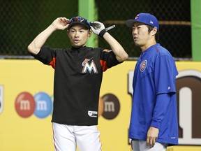 Miami Marlins' Ichiro Suzuki, left, and Chicago Cubs' Koji Uehara, both of Japan, chat before the start of a baseball game, Thursday, June 22, 2017, in Miami. (AP Photo/Wilfredo Lee)