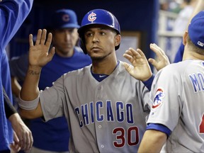 Chicago Cubs' Jon Jay (30) is congratulated after scoring on a single hit by Ian Happ during the first inning of a baseball game against the Miami Marlins, Saturday, June 24, 2017, in Miami. (AP Photo/Lynne Sladky)