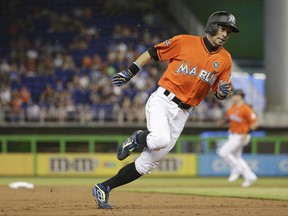 Miami Marlins' Ichiro Suzuki rounds third base on his way to score on a single hit by Marcell Ozuna during the first inning of a baseball game against the Chicago Cubs, Sunday, June 25, 2017, in Miami. (AP Photo/Lynne Sladky)