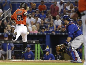 Miami Marlins' Ichiro Suzuki (51) beats the throw to Chicago Cubs catcher Miguel Montero to score on a single hit by Marcell Ozuna during the first inning of a baseball game, Sunday, June 25, 2017, in Miami. (AP Photo/Lynne Sladky)