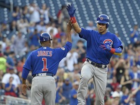 Chicago Cubs' Willson Contreras, right, celebrates his home run with third base coach Gary Jones (1) as he rounds third during the first inning of a baseball game against the Washington Nationals, Monday, June 26, 2017, in Washington. (AP Photo/Nick Wass)