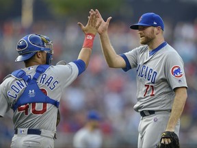 Chicago Cubs relief pitcher Wade Davis (71) celebrates the team's 5-4 win over the Washington Nationals with catcher Willson Contreras after a baseball game, hursday, June 29, 2017, in Washington. (AP Photo/Nick Wass)