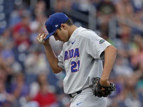 Florida pitcher Alex Faedo (21) walks on the mound in the first inning of an NCAA College World Series baseball elimination game against TCU in Omaha, Neb., Saturday, June 24, 2017. (AP Photo/Nati Harnik)
