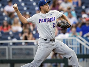 Florida's Alex Faedo (21) pitches in the bottom of the first inning during a College World Series baseball game against TCU, Saturday, June 24, 2017, in Omaha, Neb. (Ryan Soderlin/Omaha World-Herald via AP)