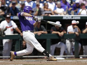 LSU's Josh Smith (4) hits an RBI single during the second inning of an NCAA College World Series baseball game against Oregon in Omaha, Neb., Friday, June 23, 2017. (AP Photo/Nati Harnik)