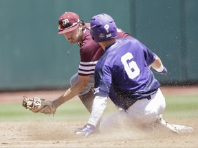 TCU's Nolan Brown (6) reaches second base before the tag by Texas A&M second baseman Braden Shewmake on a double in the second inning of an NCAA College World Series baseball elimination game in Omaha, Neb., Tuesday, June 20, 2017. (AP Photo/Nati Harnik)