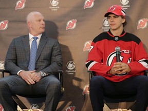 New Jersey Devils' Nico Hischier, right, and head coach John Hynes participate in a news conference in Newark, N.J., Monday, June 26, 2017. The 18-year-old center was the first Swiss-born player to be drafted first overall in the NHL draft. (AP Photo/Seth Wenig)