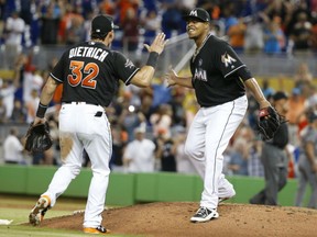 Edinson Volquez celebrates with Marlins teammate Derek Dietrich after throwing a no-hitter as the Marlins blanked the Arizona Diamondbacks 3-0 on Saturday night in Miami.