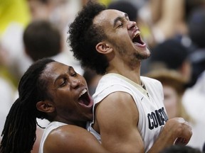 FILE - In this Jan. 28, 2017, file photo, Colorado guard Xavier Johnson, left, hoists guard Derrick White at the end of the team's NCAA college basketball game against Oregon in Boulder, Colo. Colorado won 74-65. The San Antonio Spurs selected White with the 29th pick in the NBA draft Thursday, June 22. (AP Photo/David Zalubowsk, File))