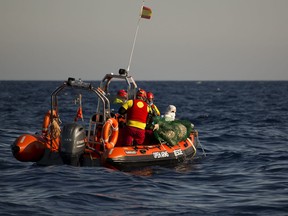 Aid workers from Proactiva Open Arms NGO recover a dead body floating on the Mediterranean sea, at 20 miles north of Zuwarah, Libya, on Wednesday, June 21, 2017