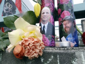 Candles with photos of Taliesin Namkai-Meche, right, and Ricky Best on them are shown at a memorial for the two men in Portland, Ore., Wednesday, May 31, 2017.
