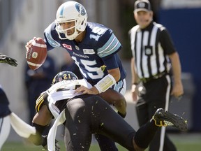 Toronto Argonauts quarterback Ricky Ray (15) is sacked by Hamilton Tiger-Cats linebacker Simoni Lawrence on June 25.