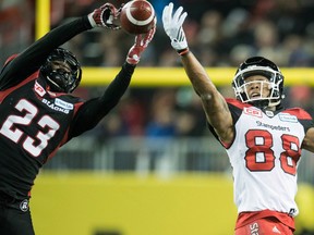 Ottawa Redblacks defensive back Forrest Hightower (left) intercepts a pass in the Grey Cup against the Calgary Stampeders on Nov. 27, 2016.