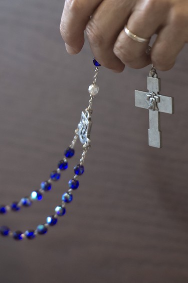 Sister Maria Kateri Frazier holds her rosary during prayers