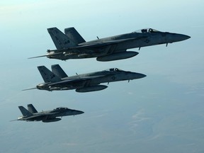 A formation of U.S. Navy F-18s leaves after receiving fuel from a KC-135 Stratotanker over northern Iraq.