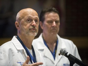 Hurley Trauma Surgeon, Dr. Donald Scholten, M.D. and Hurley Trauma and Surgical Critical Care Chief, Dr. Leo Mercer answer questions from the media during a press conference Friday June 23, 2017, at the Merliss Brown Auditorium, in Flint, Mich., to give an update regarding Lt. Jeff Neville's condition. Neville was stabbed at Bishop International Airport Wednesday morning by suspected attacker Amor Ftouhi, a Canadian from Tunisia. (Shannon Millard /The Flint Journal-MLive.com via AP)