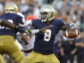 FILE - In this Sept. 5, 2015, file photo, Notre Dame quarterback Malik Zaire looks to a pass during the first half of an NCAA college football game against Texas, in South Bend, Ind. Former Notre Dame quarterback Malik Zaire says it's official: He's going to Florida. Zaire announced the news Tuesday, June 20, 2017, on Instagram with a picture of the Gators logo, saying "Official! I couldn't be happier to be a part of something special! Time to get to work. #Gators." (AP Photo/Nam Y. Huh, File)