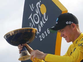 FILE - A Sunday, July 24, 2016 file photo of 2016 Tour de France winner Chris Froome of Britain celebrating on the podium after the twenty-first and last stage of the Tour de France cycling race in Paris, France. Past success aside, there isn't much to suggest that Chris Froome will cruise to a fourth Tour de France title in five years when the race rolls off in Duesseldorf, Germany, on Saturday. (AP Photo/Christophe Ena, File)