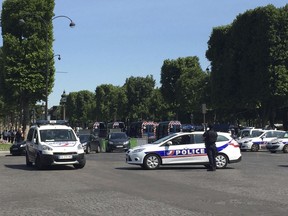 Police vehicles prevent the access to the Champs Elysees avenue in Paris, France, Monday, June 19, 2017. Paris officials say a suspected attacker was "downed" after driving into police car.
