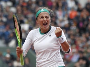 Latvia's Jelena Ostapenko clenches her fist after scoring a point against Denmark's Caroline Wozniacki in a French Open quarter-final on June 6.