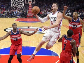 FILE - In this March 29, 2017, file photo, Los Angeles Clippers forward Blake Griffin, second from left, shoots as Washington Wizards center Ian Mahinmi, left, guard Bradley Beal, second from right, and forward Otto Porter Jr. defend during an NBA basketball game in Los Angeles. A person with knowledge of the situation says Griffin has agreed to a five-year deal worth approximately $175 million to remain with the Clippers. Griffin and the Clippers agreed Friday night, June 30, 2017, on a new deal, one that will be signed when the league's moratorium on offseason moves ends on July 6. (AP Photo/Mark J. Terrill, File)