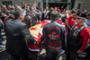 Members of the North Wall Riders Association carry the casket while a veteran salutes during the funeral for Nazzareno Tassone in his hometown of Niagara Falls, Ont., June 21, 2017.