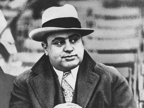 FILE - In this Jan. 19, 1931 file photograph, Chicago mobster Al Capone is seen at a football game in Chicago. Artifacts connected to some of the nation's most notorious gangsters are being auctioned this weekend. A handwritten musical composition by Al Capone, a letter written by a jailed John Gotti asking someone to "keep the martinis cold," and jewelry that belonged to Bonnie and Clyde are among the items up for bid Saturday in the "Gangsters, Outlaws and Lawmen" auction in Cambridge, Mass. (AP Photo/File)