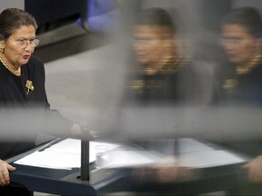 FILE - In this Jan.27 2002 file photo, Simone Veil is reflected in a pane of glass as she addresses the German Parliament during a commemorative ceremony for the victims of the Nazi regime in the Reichstag building in Berlin. Simone Veil, a Nazi death camp survivor and prominent French politician who spearheaded abortion rights, dies. (AP Photo/Markus Schreiber, File)