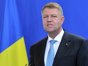 The president of Romania, Klaus Johannis talks during a joint media conference with German chancellor Angela Merkel in Berlin, Germany, Monday June 19, 2017. (Maurizio Gambarini/dpa via AP)