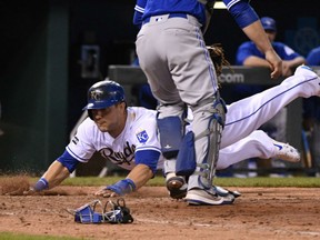 Alex Gordon of the Kansas City Royals scores the game-winning run in the bottom of the ninth inning, giving the Royals a 5-4 victory over the Toronto Blue Jays in MLB action Friday in Kansas City. The Royals spotted the Jays a 4-1 lead with two out before rallying for the victory.