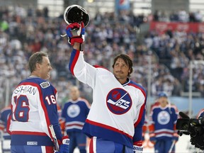 In this Oct. 22, 2016 file photo, former Winnipeg Jets player Teemu Selanne waves to the crowd at Investors Group Field before the NHL Heritage Classic Alumni game.