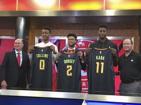 Atlanta Hawks general manager Travis Schlenk, left, stands with coach Mike Budenholzer, right, and with draft picks John Collins, Tyler Dorsey and Alpha Kaba, Monday, June 26, 2017, in Atlanta. (AP Photo/Charles Odum)