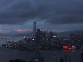 In this June 24, 2017 photo, an electronic monitor shows the China national flags outside a shopping center in Hong Kong to mark the 20th anniversary of Hong Kong handover to China. Hong Kong is planning a big party as it marks 20 years under Chinese rule. But many people in the former British colony are not in the mood to celebrate. (AP Photo/Vincent Yu)