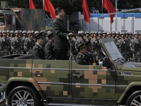 Chinese President Xi Jinping inspects the Chinese troops of People's Liberation Army (PLA) Hong Kong Garrison at the Shek Kong Barracks in Hong Kong, Friday, June 30, 2017. Chinese President landed in Hong Kong Thursday to mark the 20th anniversary of Beijing taking control of the former British colony, accompanied by a formidable layer of security as authorities showed little patience for pro-democracy protests. (AP Photo/Kin Cheung)