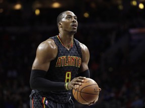 FILE - In this March 29, 2017, file photo, Atlanta Hawks' Dwight Howard prepares to shoot a free throw during the team's NBA basketball game against the Philadelphia 76ers in Philadelphia. A person familiar with the situation says the Charlotte Hornets have reached an agreement to acquire center Howard from the Hawks. The Hawks are sending Howard and the No. 31 overall pick in Thursday's NBA draft to Charlotte for center Miles Plumlee, shooting guard Marco Belinelli and the 41st pick, the person told The Associated Press on condition of anonymity Tuesday, June 20, because the trade is not yet official. (AP Photo/Matt Slocum, File)