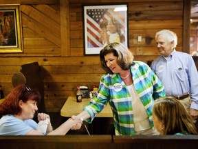 Karen Handel, Republican candidate for Georgia's 6th congressional district, center, greets diners during a campaign stop at Old Hickory House in Tucker, Ga., Monday, June 19, 2017. The race between Handel and Democrat Jon Ossoff is seen as a significant political test for the new Trump Administration. The district traditionally goes Republican, but most consider the race too close to call as voters head to the polls on Tuesday. (AP Photo/David Goldman)